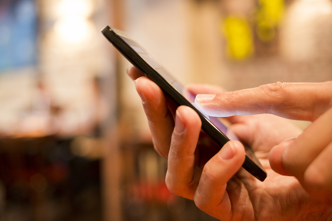 person with cellphone in hand